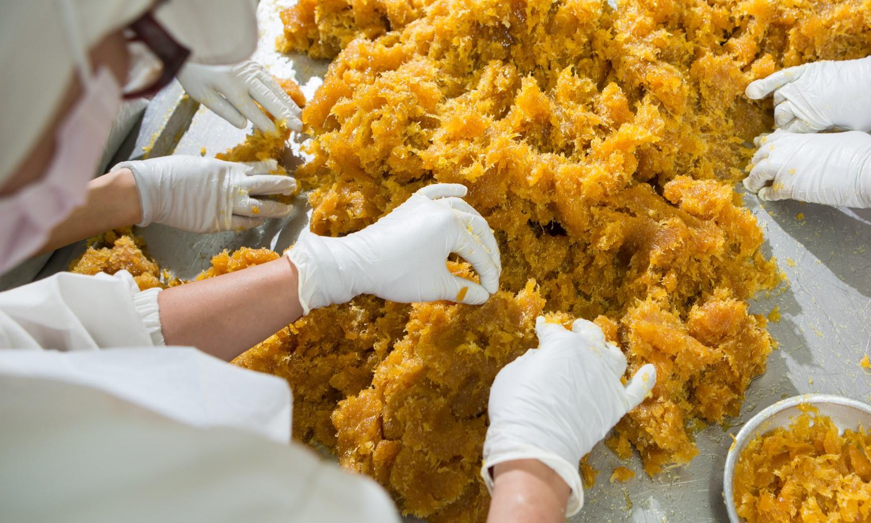 staff managing pineapple fillings